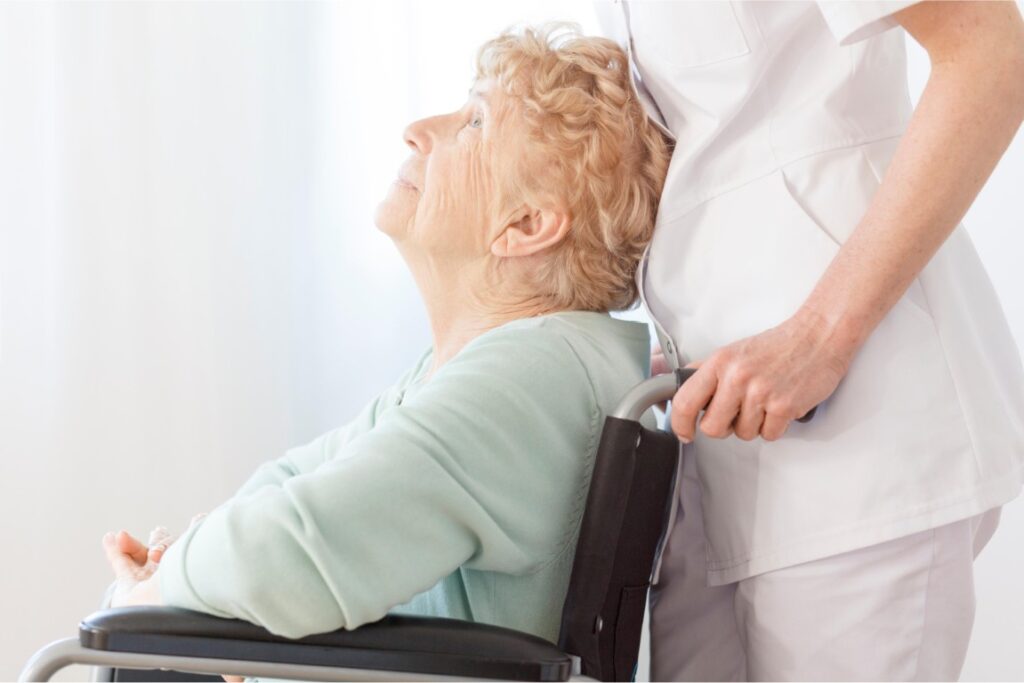 Nurse is pushing woman wheelchair